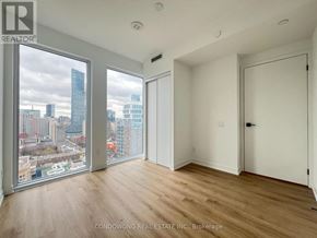 Toronto (Moss Park) condo for rent - A room with a view of the city skyline through the windows.
