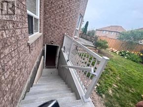 Halton Hills (Georgetown) apartment for rent - A staircase with a railing leads to a doorway in a brick building.