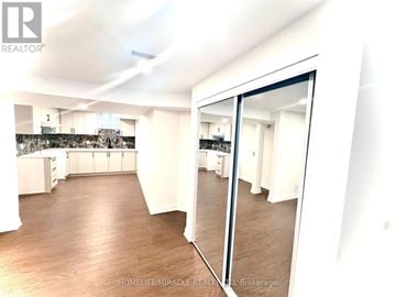 Halton Hills (Georgetown) apartment for rent - A spacious kitchen with white cabinets and a large island.
