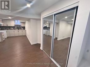 Halton Hills (Georgetown) apartment for rent - A spacious room with a large mirror on the wall.