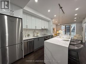 Toronto (Church-Yonge Corridor) condo for rent - A modern kitchen with stainless steel appliances and a dining area with a table set for two.