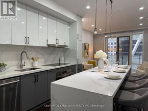Toronto (Church-Yonge Corridor) condo for rent - A modern kitchen with a large island and a dining area.