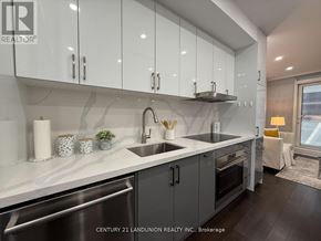 Toronto (Church-Yonge Corridor) condo for rent - A modern kitchen with white cabinets and a marble backsplash.