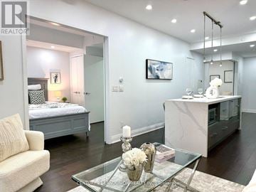 Toronto (Church-Yonge Corridor) condo for rent - A living room with a glass coffee table and a white sofa.