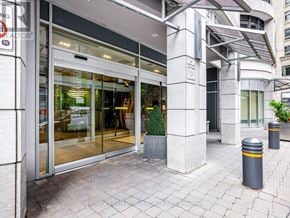 Toronto (Church-Yonge Corridor) condo for rent - The image shows the front of a building with a glass door entrance and a small tree in a planter.