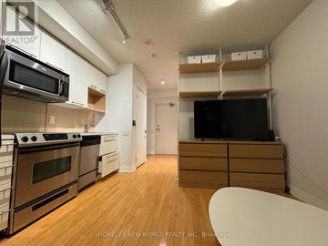 Toronto (Church-Yonge Corridor) condo for rent - A kitchen with wooden floors and stainless steel appliances.