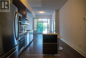 Toronto (Willowdale East) condo for rent - A modern kitchen with stainless steel appliances and a bar stool.