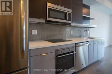 Toronto (Willowdale East) condo for rent - A modern kitchen with a stainless steel refrigerator and a microwave above the stove.