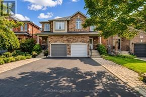 Burlington (Uptown) apartment for rent - A house with a driveway and garage in front of it.