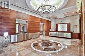 Toronto (Bay Street Corridor) condo for rent - A large, modern lobby with a circular marble floor and a chandelier.
