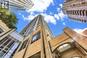 Toronto (Bay Street Corridor) condo for rent - A tall building with the words "HOMELAND NEW WORLD" on it.