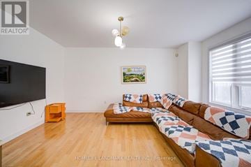Markham (Wismer) apartment for rent - A living room with a couch and a television.