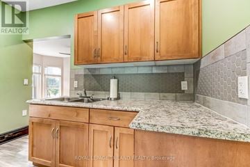 St. Thomas apartment for rent - A kitchen with wooden cabinets and a marble countertop.
