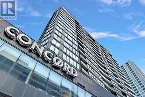 Toronto (Waterfront Communities) condo for rent - The Concord building is a tall, modern skyscraper with a glass facade.