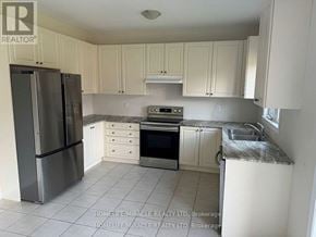 Brock (Beaverton) apartment for rent - A kitchen with white cabinets and a stainless steel refrigerator.