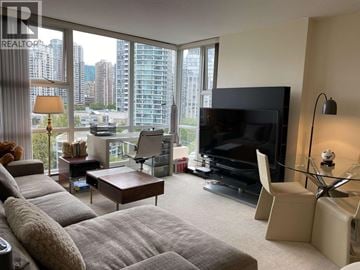 Vancouver apartment for rent - A living room with a grey couch and a television.