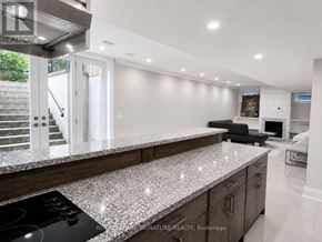 Toronto (Willowdale West) apartment for rent - A modern kitchen with a granite countertop and stainless steel appliances.