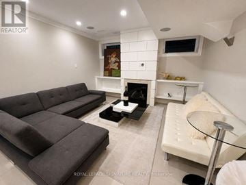 Toronto (Willowdale West) apartment for rent - A living room with a grey couch and a white sofa.