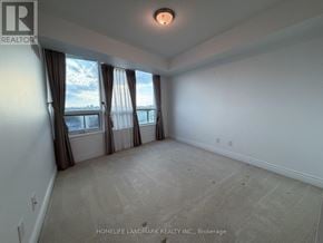 Toronto (Newtonbrook West) condo for rent - A spacious room with a large window and carpeted floor.