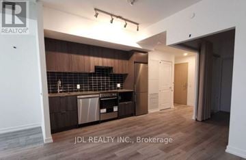 Toronto (North St. James Town) condo for rent - A kitchen area with wooden cabinets and a countertop.