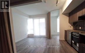 Toronto (North St. James Town) condo for rent - A kitchen area with a stove top oven and microwave.