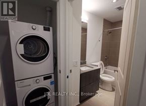 Toronto (North St. James Town) condo for rent - A white washer and dryer in a small bathroom.
