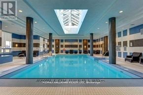 Toronto (Willowdale East) condo for rent - A large indoor swimming pool with a skylight above it.