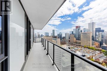 Toronto (University) condo for rent - A balcony with a view of a city skyline.