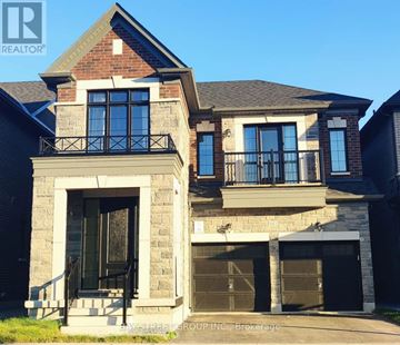Pickering apartment for rent - A house with a balcony and a garage door.