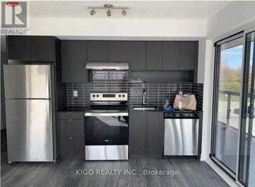 Burlington (Lasalle) condo for rent - A modern kitchen with a stainless steel refrigerator and dishwasher.
