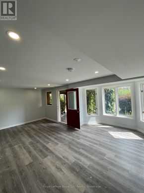 Guelph (Pineridge/Westminster Woods) apartment for rent - A spacious room with wooden flooring and a large window.