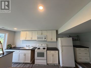 Guelph (Pineridge/Westminster Woods) apartment for rent - A kitchen with white cabinets and appliances.