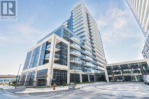 Milton (Tm Timberlea) condo for rent - A modern multi-story building with a glass facade and a crane in the background.