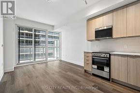 Milton (Tm Timberlea) condo for rent - A spacious kitchen with wooden cabinets and a stainless steel oven.