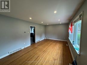 London East (East D) apartment for rent - A room with wooden flooring and a window with a view of a street.