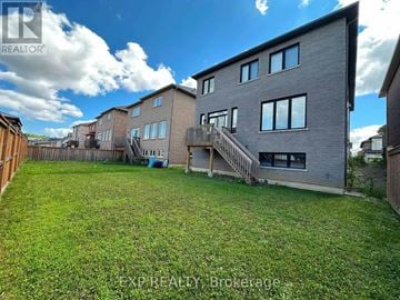 Hamilton (Ancaster) apartment for rent - A large grassy yard in front of a grey building.