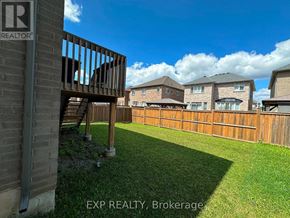 Hamilton (Ancaster) apartment for rent - A sunny day in a residential area with houses and a wooden fence.