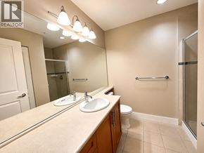 Vancouver apartment for rent - A bathroom with a sink, mirror, and toilet.