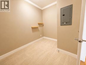 Vancouver apartment for rent - A room with a carpeted floor, a door, and a wall-mounted electrical panel.