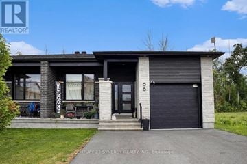 North Stormont apartment for rent - A house with a garage and a sign that says Century 21 Synergy Realty Inc. Brokerage.