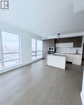 Richmond Hill (South Richvale) condo for rent - A spacious kitchen with a view of the city through large windows.