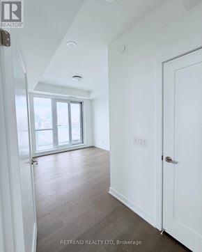 Richmond Hill (South Richvale) condo for rent - A white door is on the right side of a room with a window.
