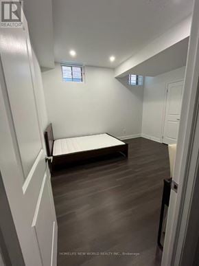 Markham (Cornell) apartment for rent - A bedroom with a bed, wooden floors, and white walls.