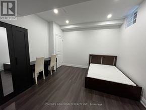 Markham (Cornell) apartment for rent - A bedroom with a bed, chair, and wardrobe.