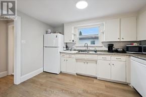 Guelph (St. Patrick's Ward) triplex for rent - A kitchen with white appliances and cabinets.