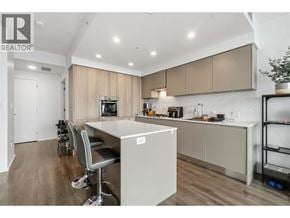 Burnaby apartment for rent - A modern kitchen with a large island and a dining area.