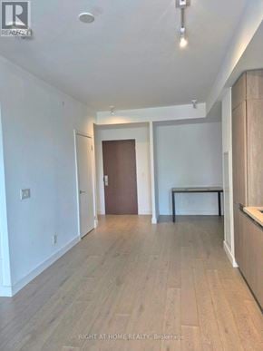 Toronto (Edenbridge-Humber Valley) condo for rent - A spacious room with wooden flooring and white walls.