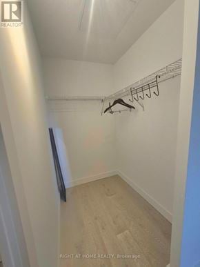 Toronto (Edenbridge-Humber Valley) condo for rent - A hallway with a coat rack and a door on the left.