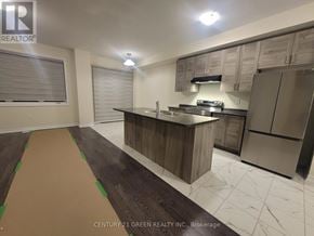 Thorold (Rolling Meadows) townhouse for rent - A kitchen with a wooden island and stainless steel appliances.