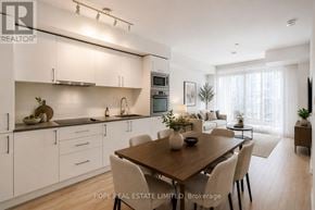 Toronto (Waterfront Communities) condo for rent - A modern kitchen with a dining table and chairs.